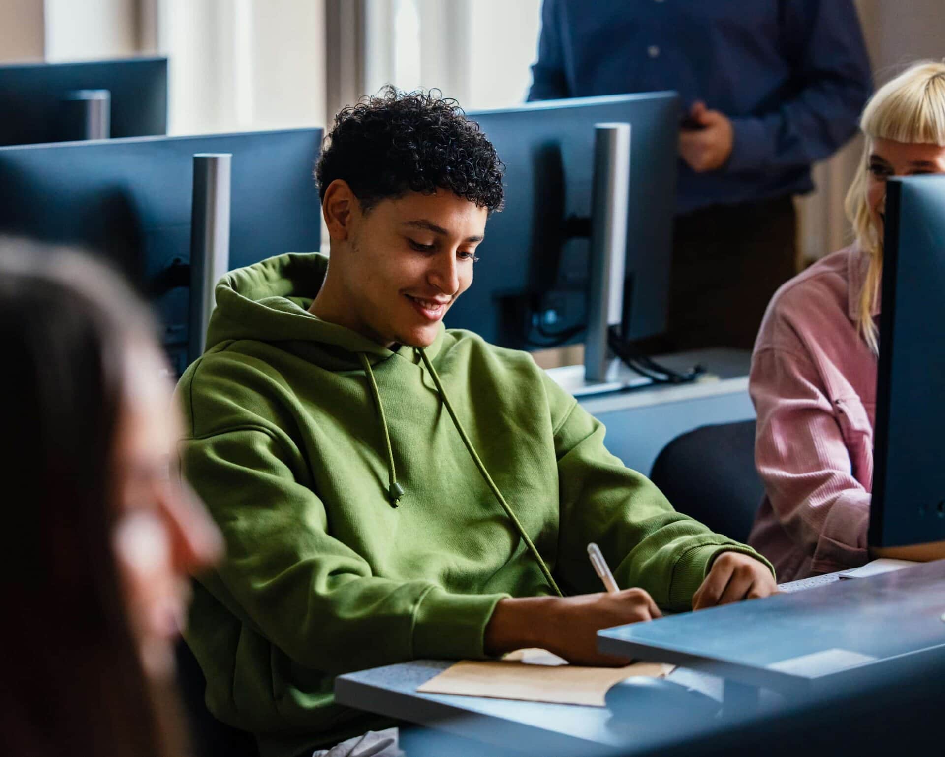 Student engaging with computer science coursework in a classroom setting.