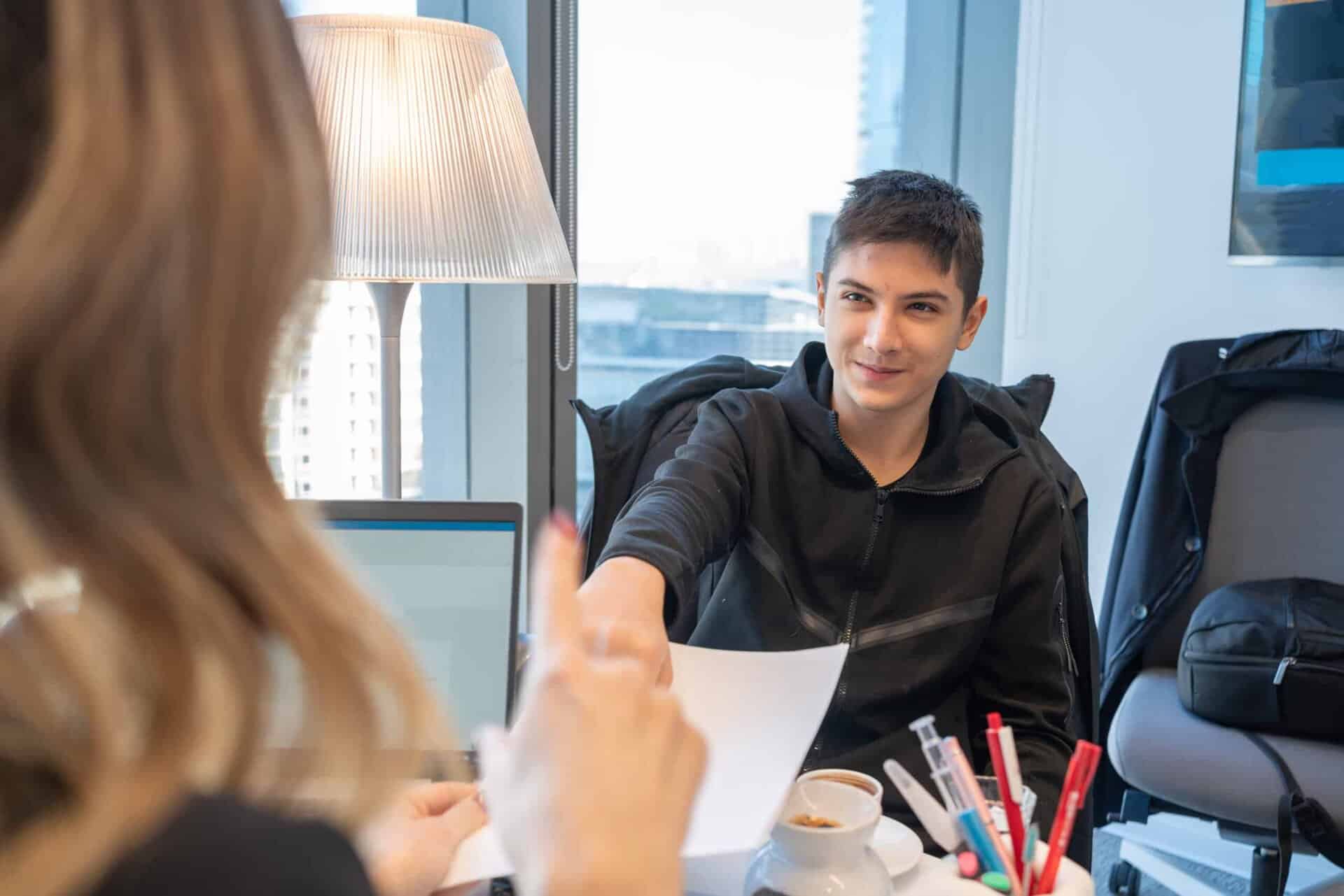 Young professional male student engaging in a business discussion at Sapphire Education.